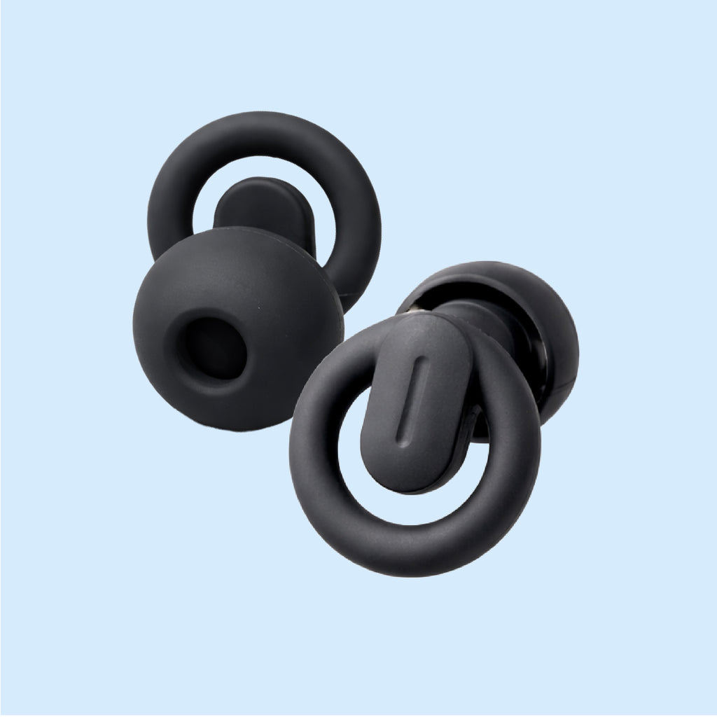 Black silicone earbud tips on a light blue background