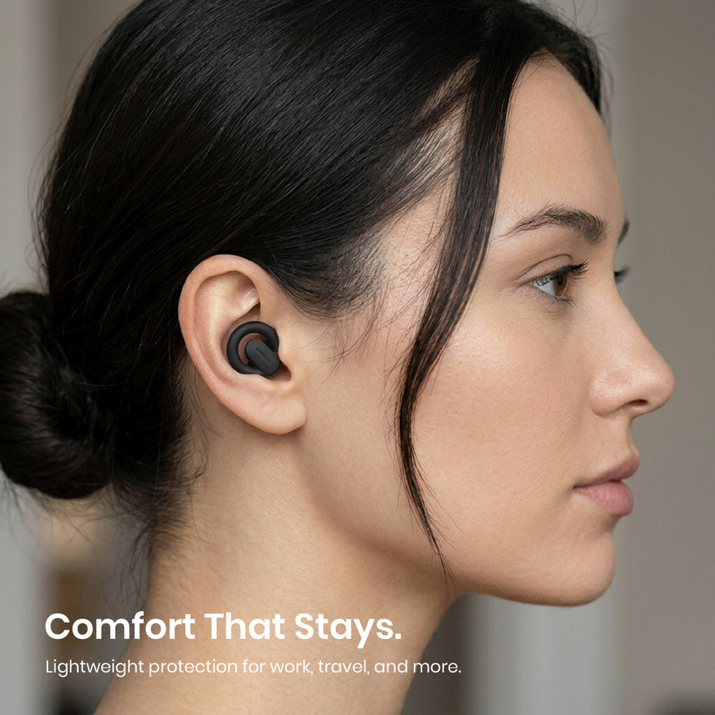 Woman wearing wireless earbuds with text 'Comfort That Stays' on a neutral background