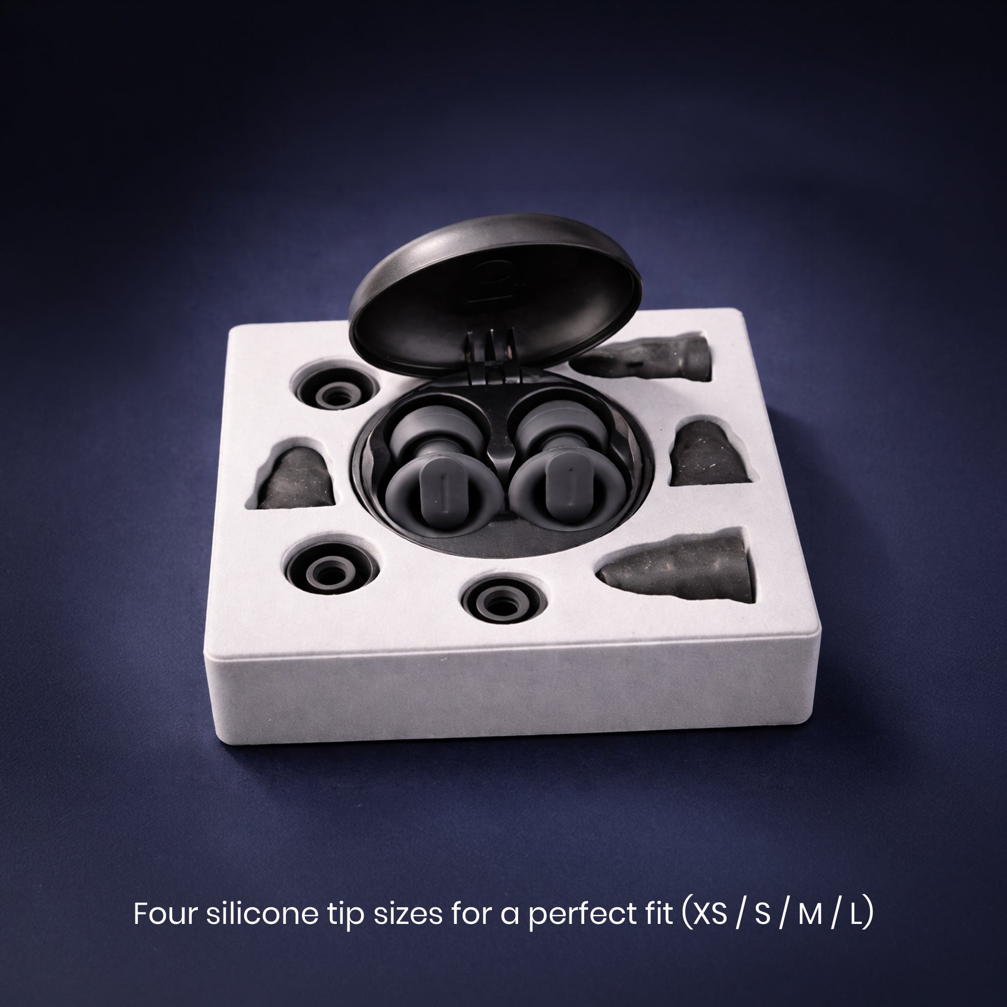 Set of silicone earbud tips in a box on a dark background
